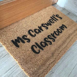 Doormat that says the teacher's name, Ms Carswell's, with classroom underneath.