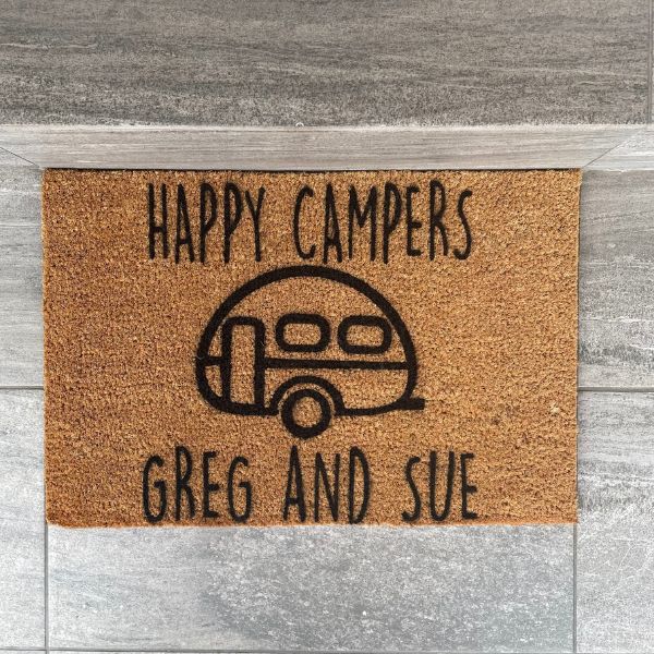 Doormat that says 'Happy Campers Greg and Sue'