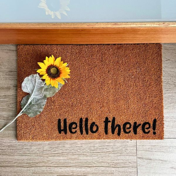 Doormat that says 'Hello there!' with a sunflower
