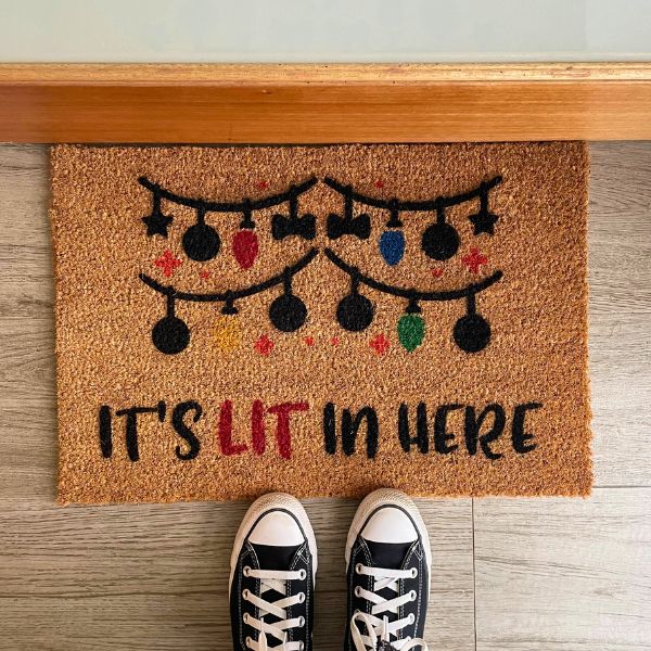 Doormat that says 'It's lit in here'
