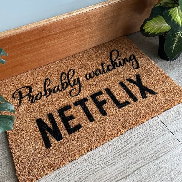 Doormat that says 'Probably watching Netflix'