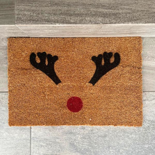 Doormat with reindeer antlers and red nose