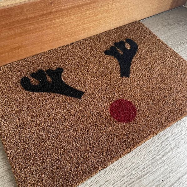 Doormat with reindeer antlers and red nose