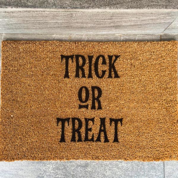 Halloween doormat that says Trick or Treat