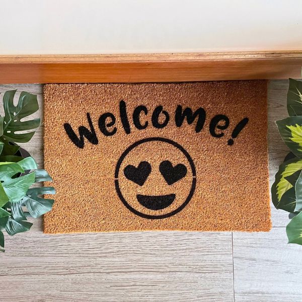 Welcome doormat with heart eyes emoji