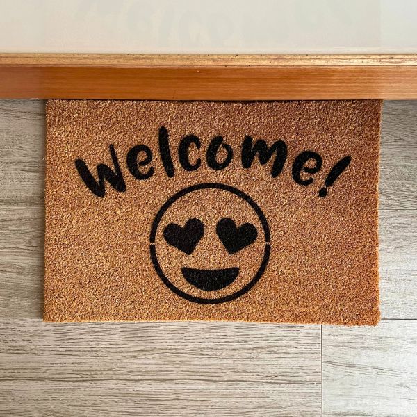 Welcome doormat with heart eyes emoji