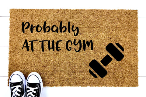 Doormat that says Probably At The Gym with a picture of a dumbbell