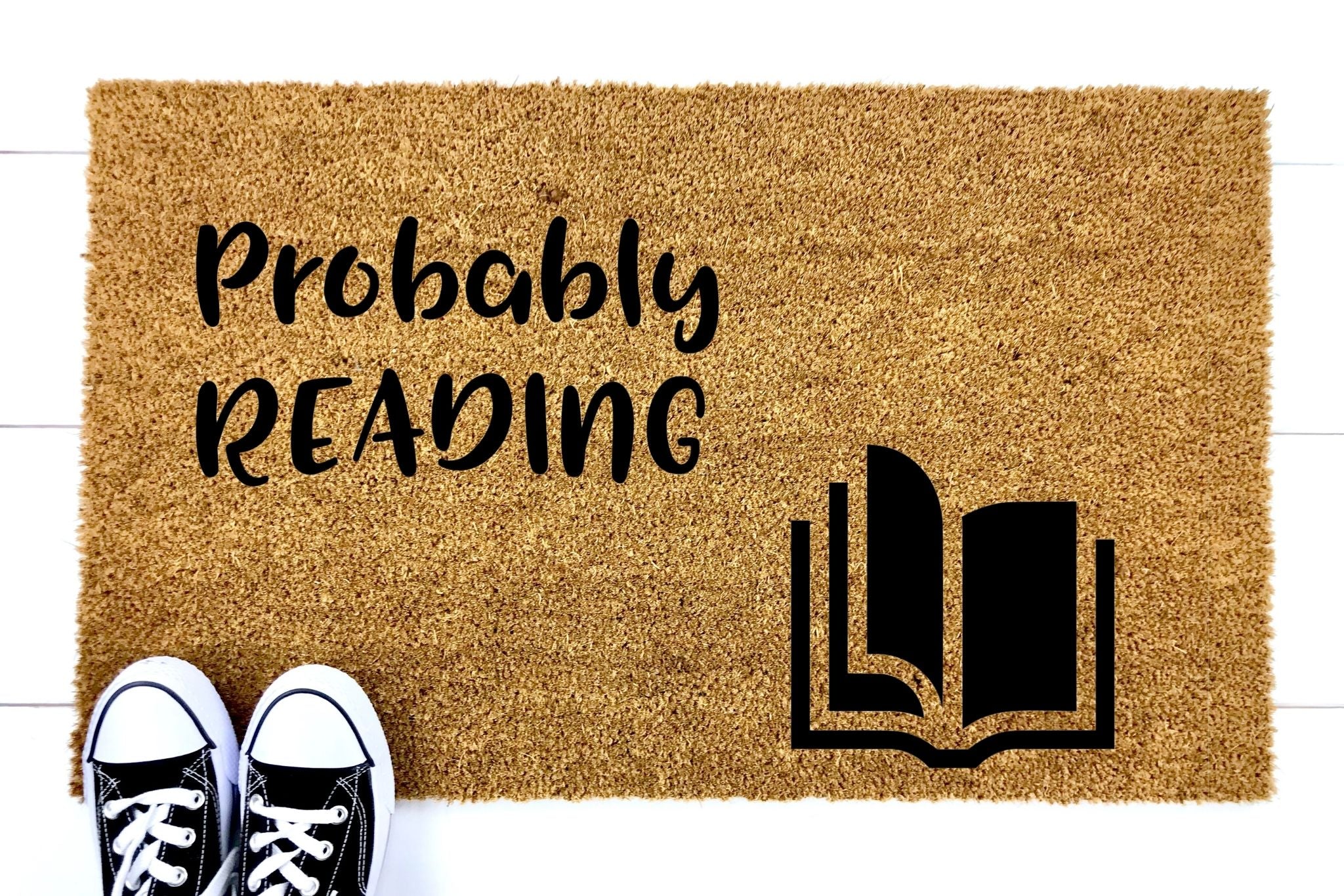 Doormat that says 'Probably Reading' with a picture of a book